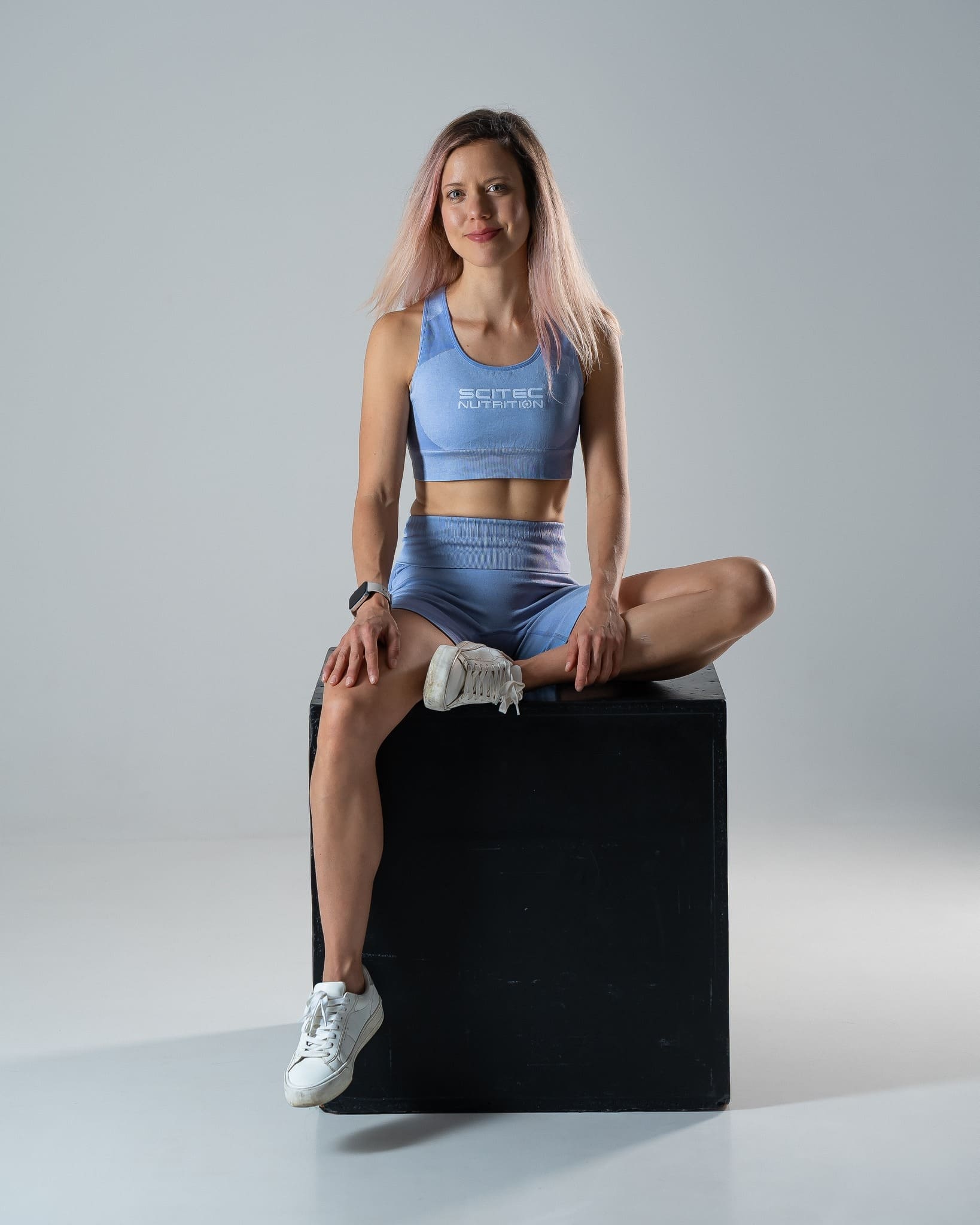 Professional fitness trainer smiling empathetically